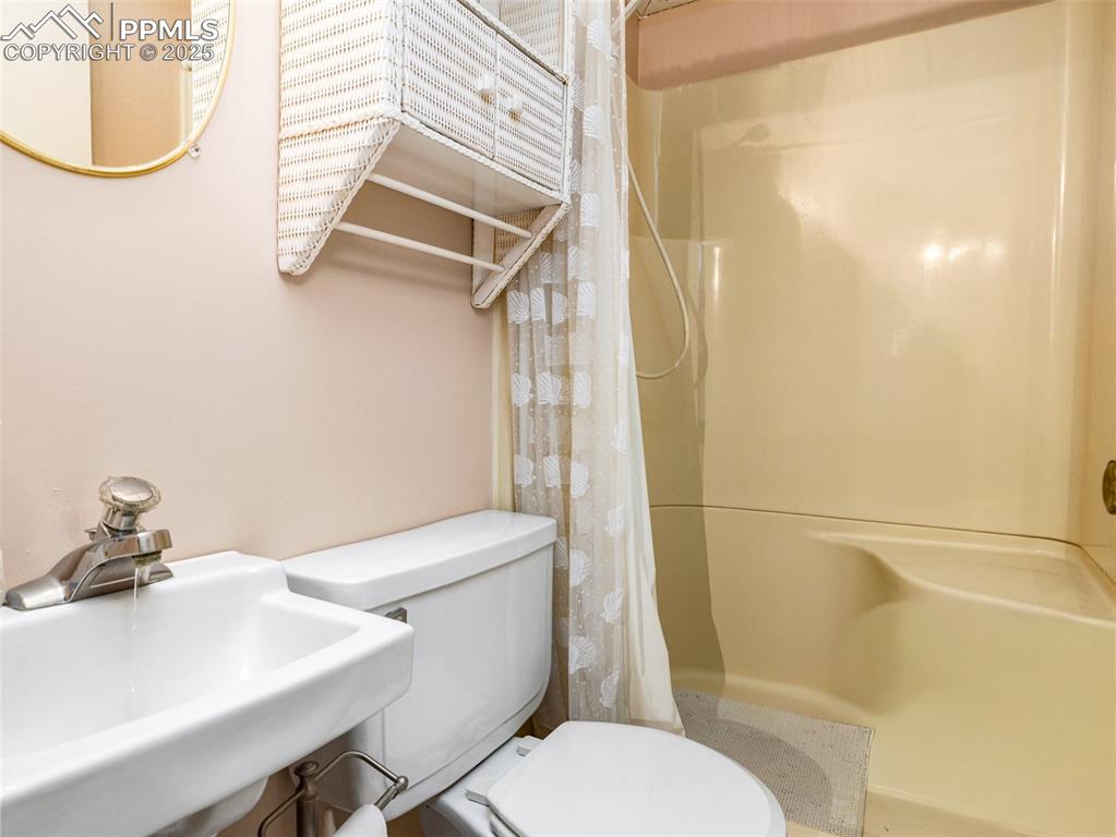 Bathroom featuring a sink and a stall shower