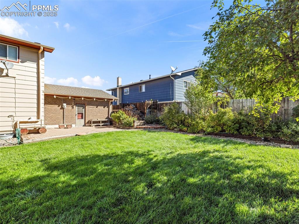 Fenced backyard with a patio