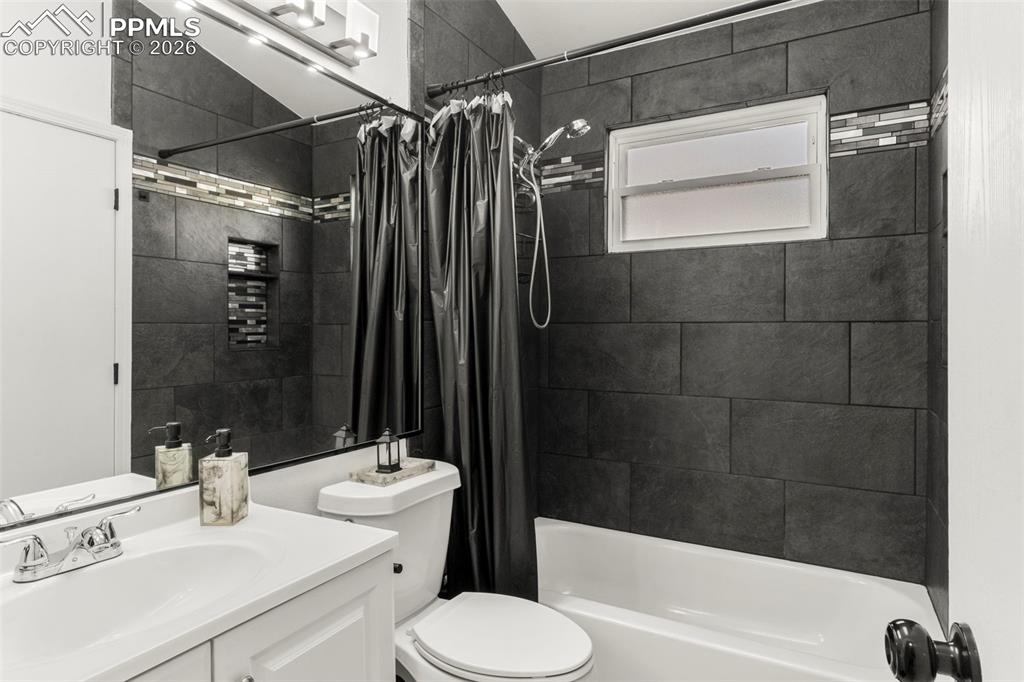 Full bath featuring vanity and shower / tub combo