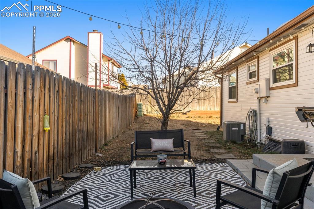 Fenced backyard with a patio area and an outdoor living space