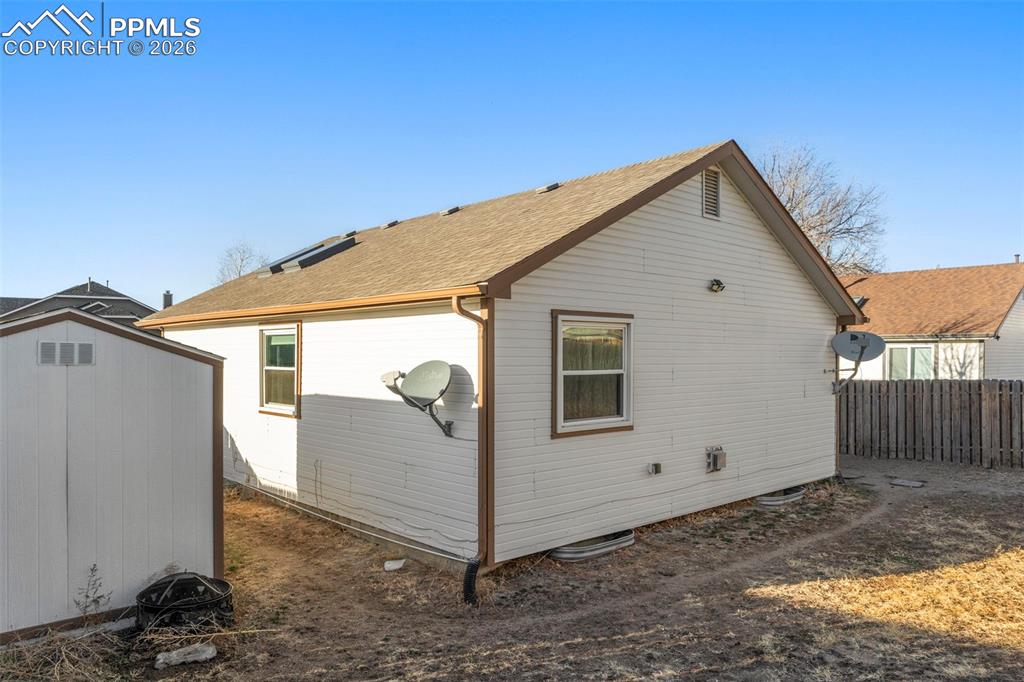 View of home's exterior with a shed