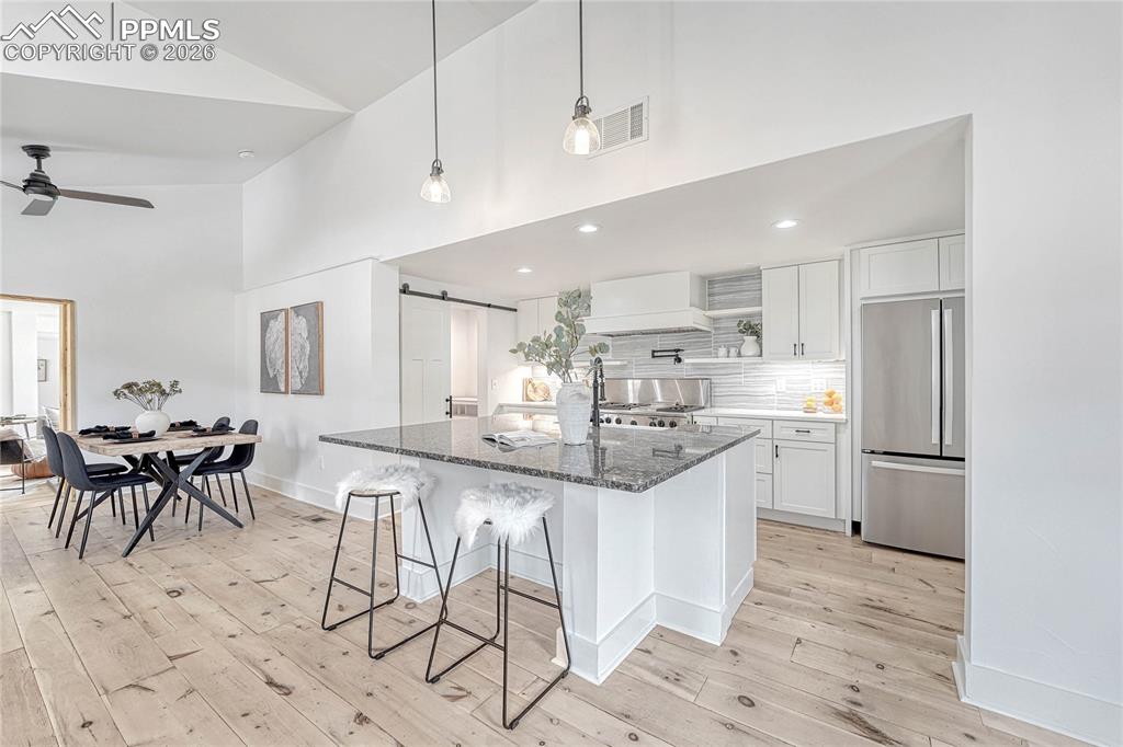 Modern Kitchen, Wood Flooring, Refrigerator, Cabinets, Ceiling Fan