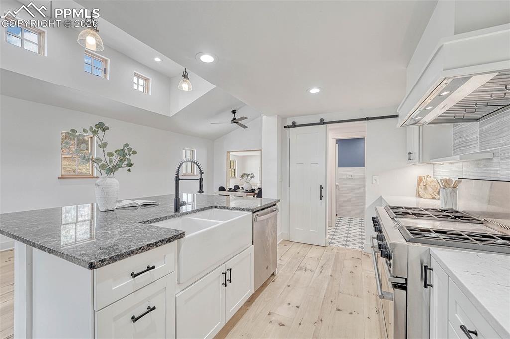 Modern Kitchen, sink, stainless steel appliances, Wood floors, ceiling fan,