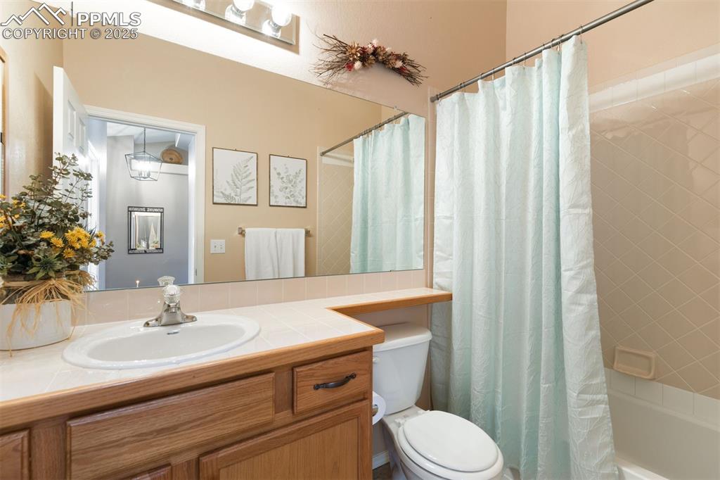 Main level full bathroom with tile flooring