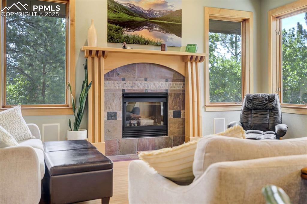 Living room featuring a tiled fireplace and wood finished mantle