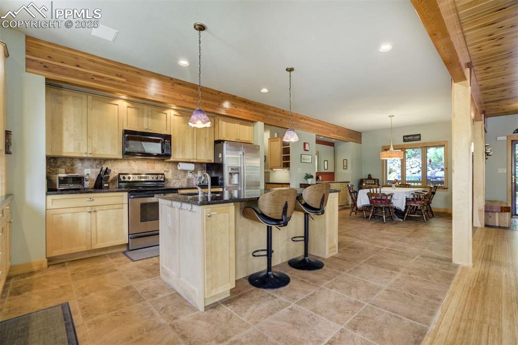Kitchen featuring the island and bar stools. 