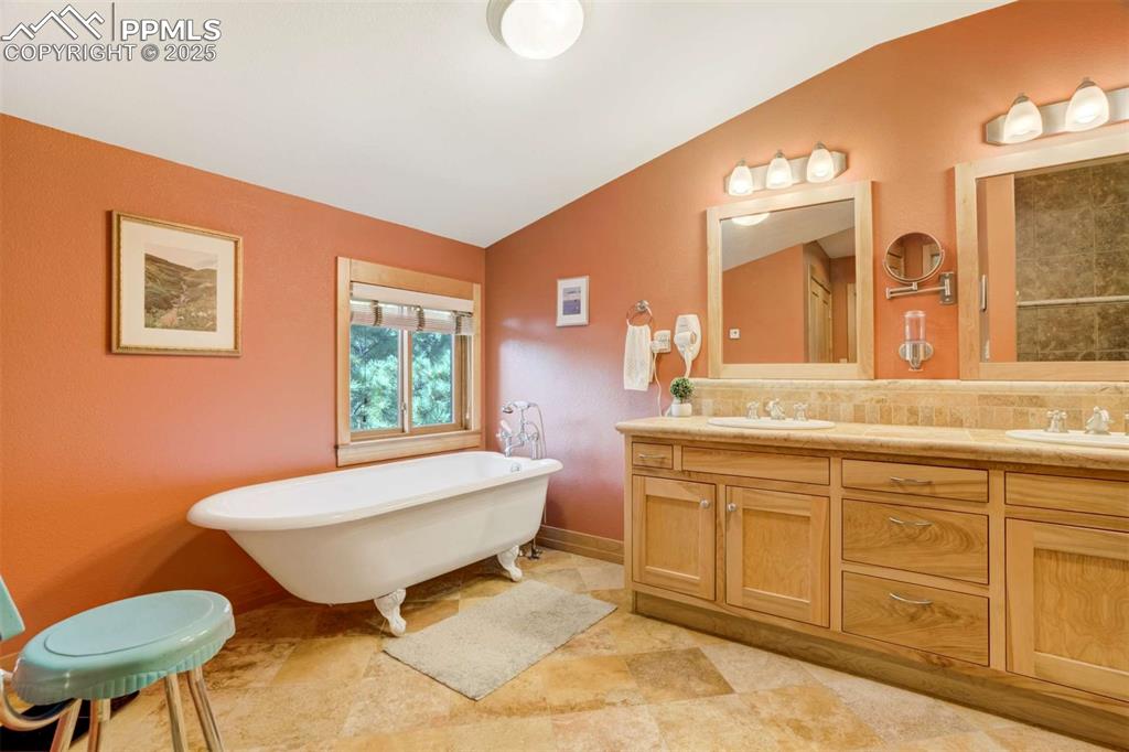 5-piece bathroom with vaulted ceiling, a freestanding bath, and double vanity