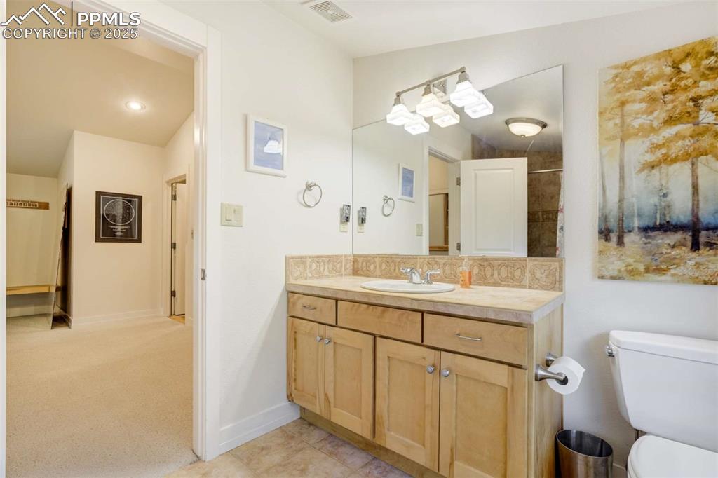 3rd guest bathroom featuring vanity and tile patterned floors