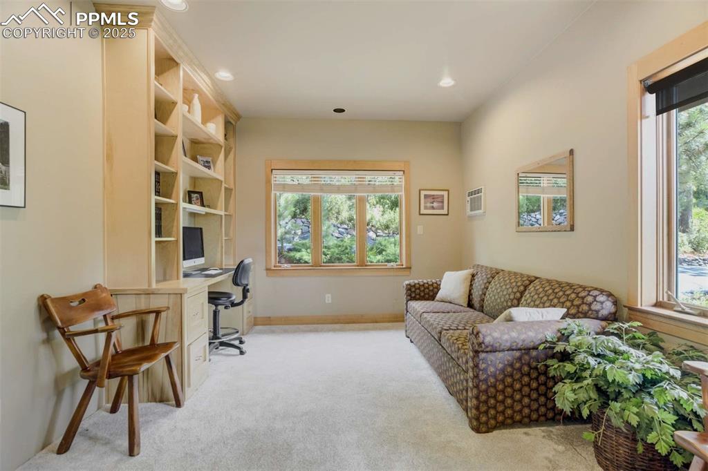 Office area with light colored carpet and recessed lighting