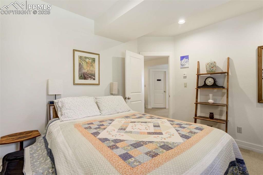 Bedroom with light carpet and recessed lighting
