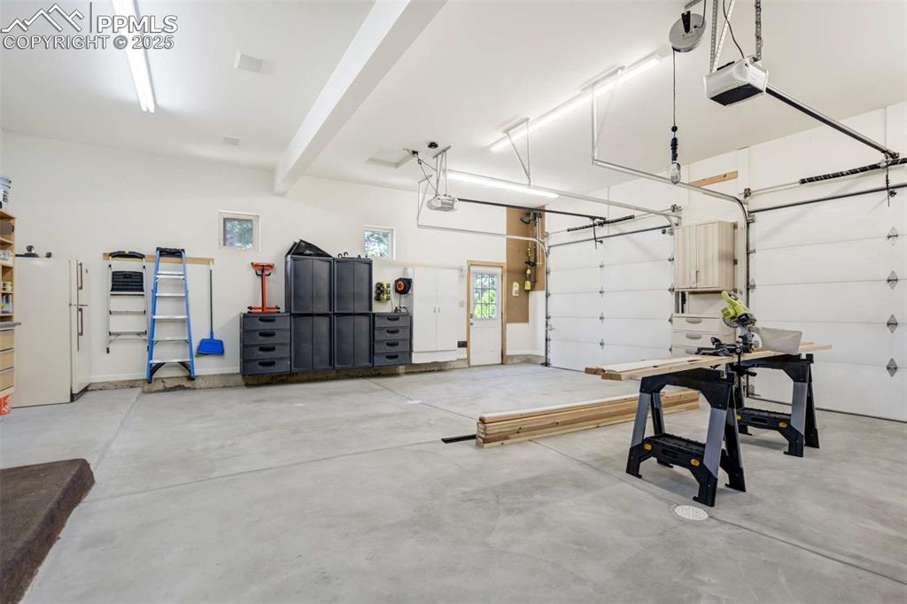 Garage featuring newly poured floor, clean and organized and lots of room