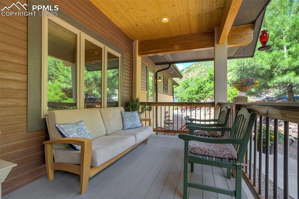 Wooden deck featuring an outdoor living space  It also has a trap door in the floor for extra storage.