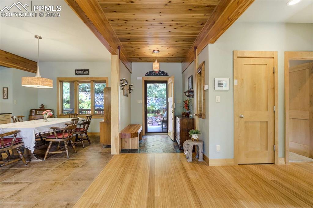 Entrance foyer featuring a wooden ceiling with exposed beams and bamboo floors
