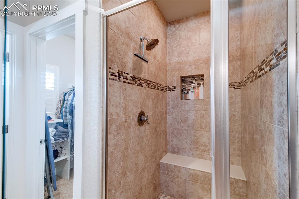 Bathroom with a shower and a spacious closet