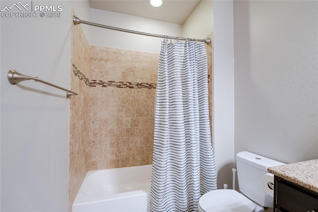 Full bathroom featuring vanity and shower / bath combo with shower curtain
