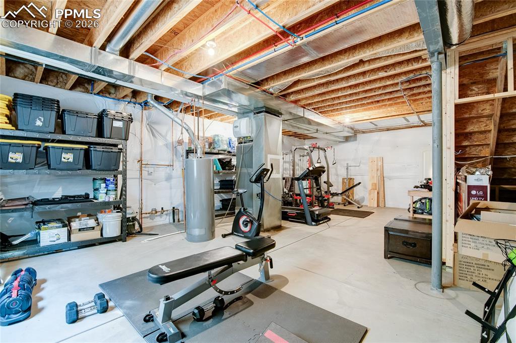 Unfinished room utility room in basement used as an exercise room