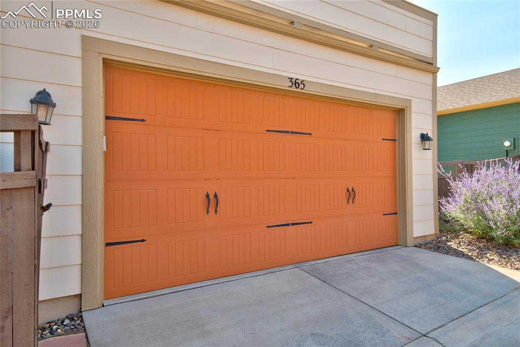 Garage featuring concrete driveway