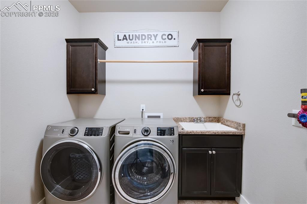 Laundry area with independent washer and dryer and cabinet space