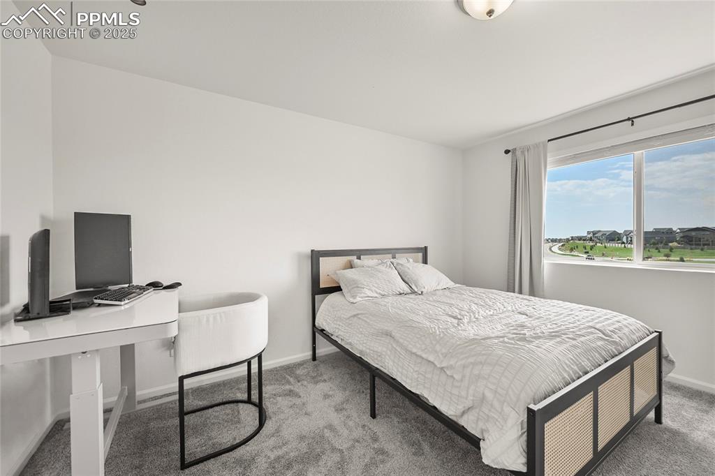 Bedroom with carpet and baseboards