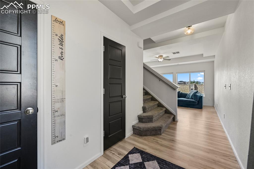 Foyer entrance featuring light wood-style flooring and stairway