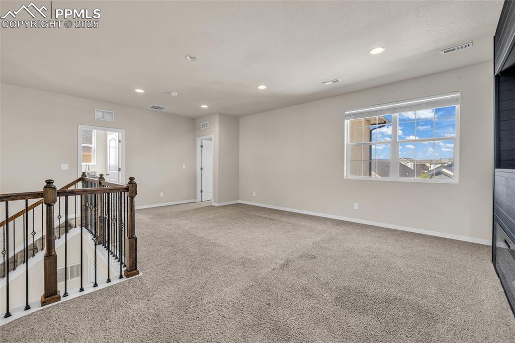 Empty room featuring light colored carpet and recessed lighting