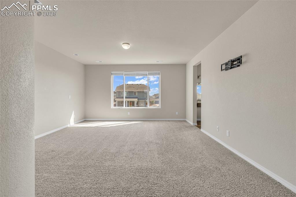 Unfurnished room with carpet and baseboards