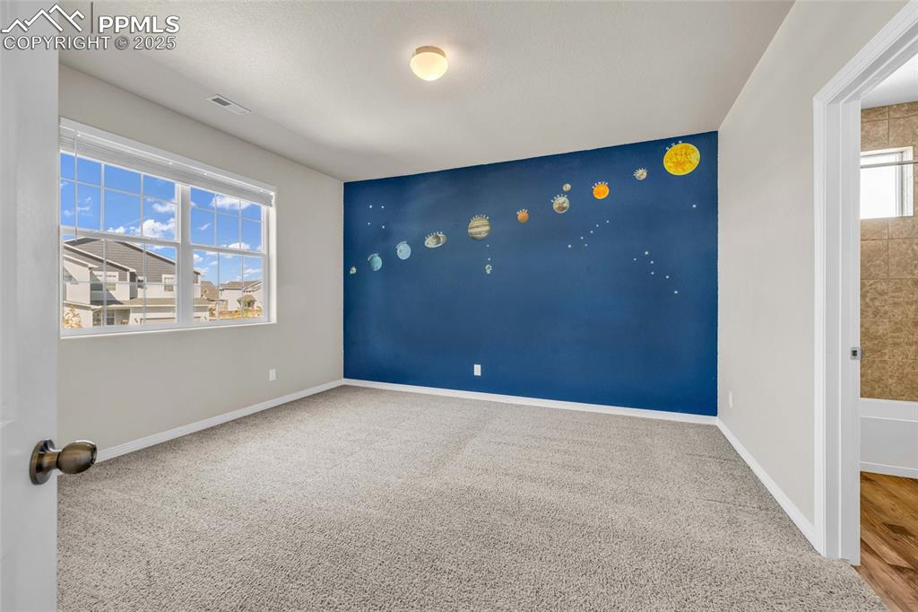 Carpeted spare room with baseboards