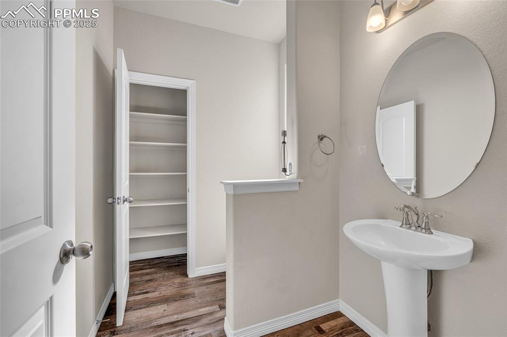 Bathroom with wood finished floors and a spacious closet
