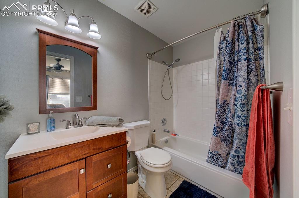 The Primary Bathroom offers a vanity, framed mirror, and tub/shower.