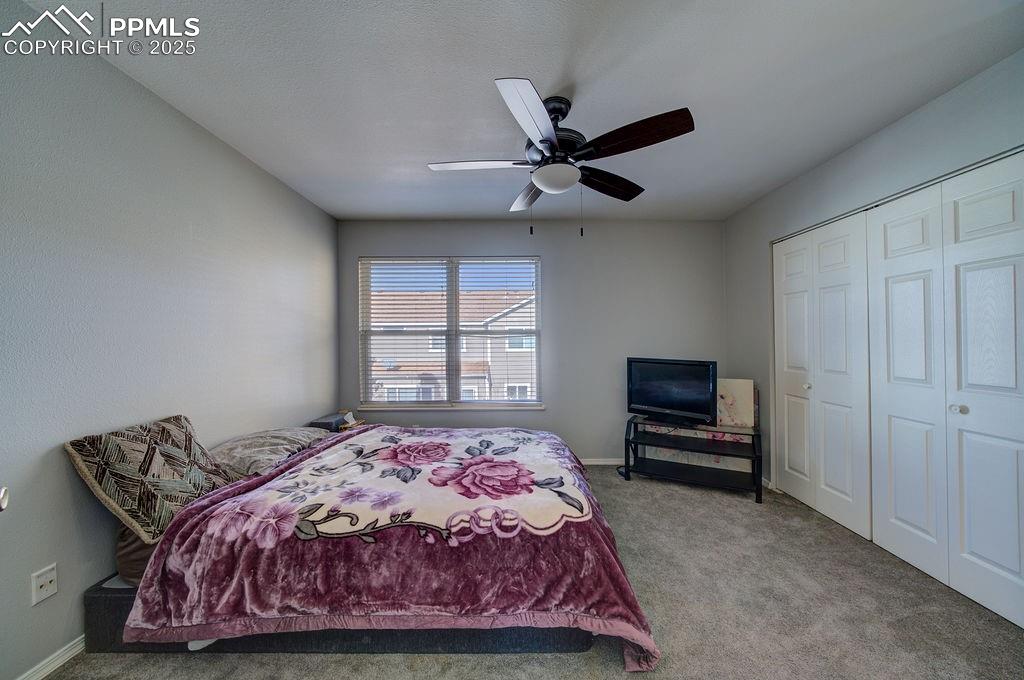 Upper level Bedroom #2 has neutral carpet, a lighted ceiling fan, a closet, and adjoining bathroom.