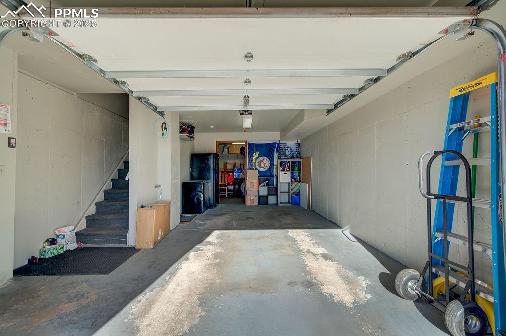 Oversized 1 car garage with door opener and storage.