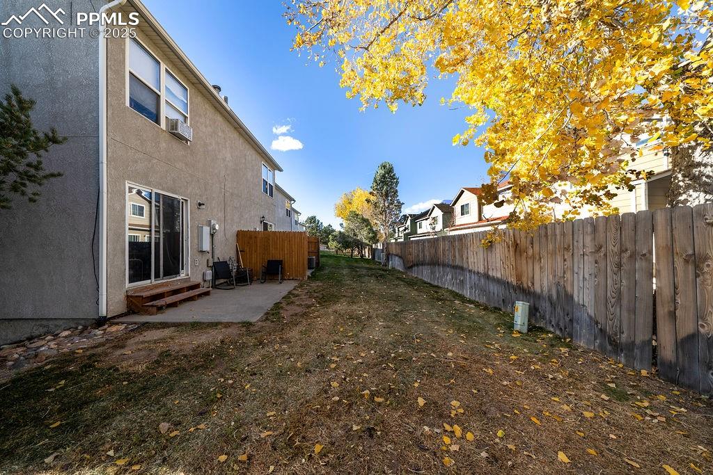 Rear view of building with private patios and grass area.