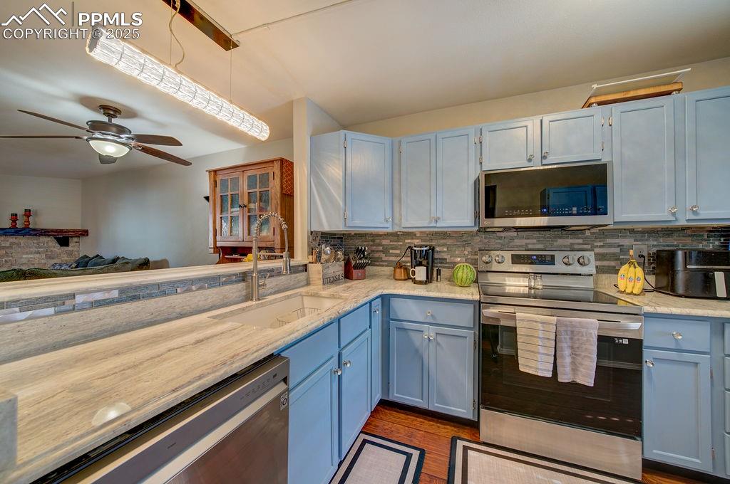 Stainless steel appliances include a dishwasher, smooth top range oven, built-in microwave, and French door refrigerator.