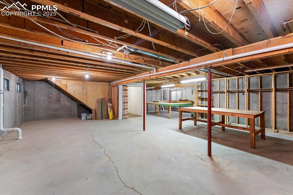 Unfinished below grade area featuring pool table