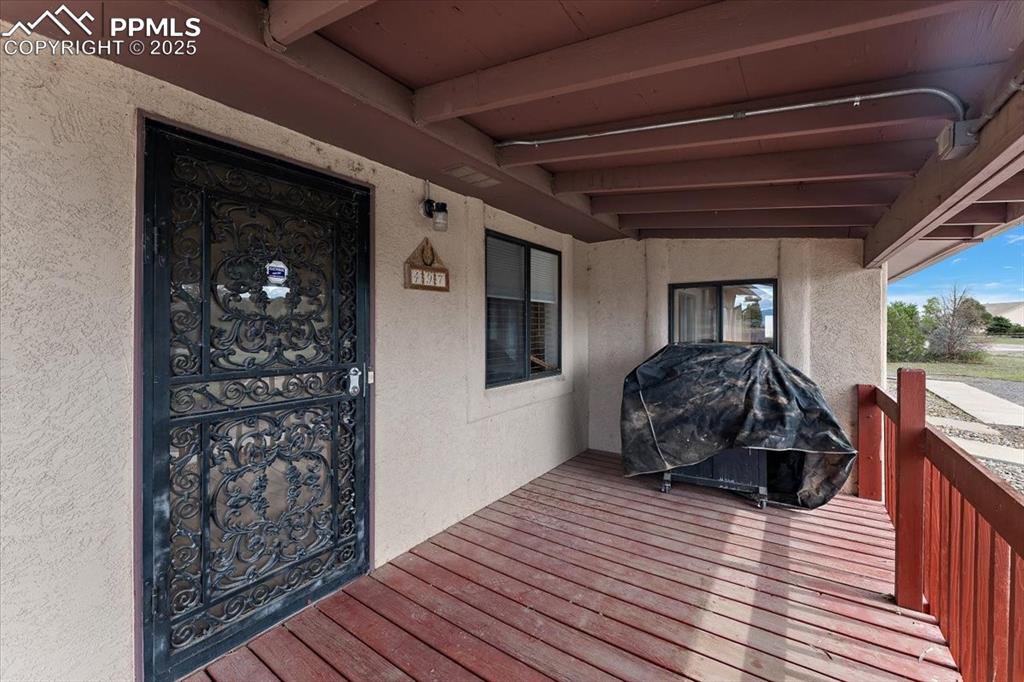 Wooden terrace featuring area for grilling