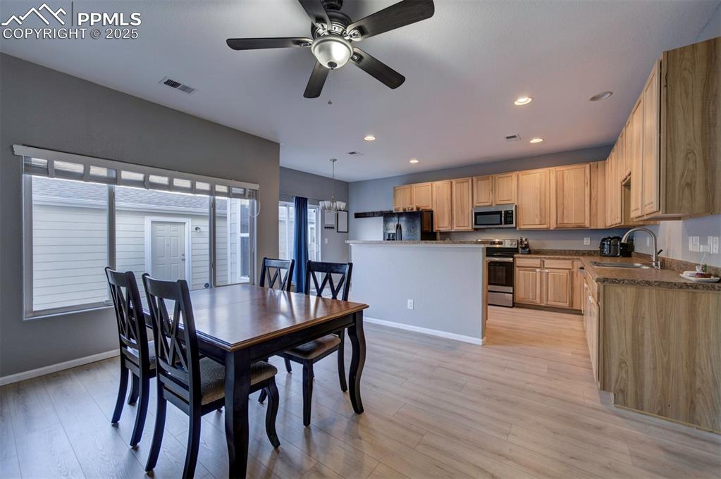 Dining room featuring light wood finished floors, recessed lighting, and ceiling fan