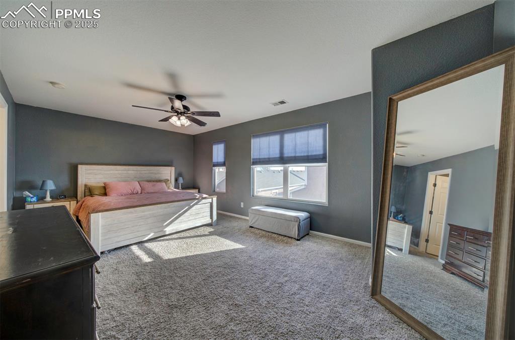 Bedroom with carpet floors and a ceiling fan
