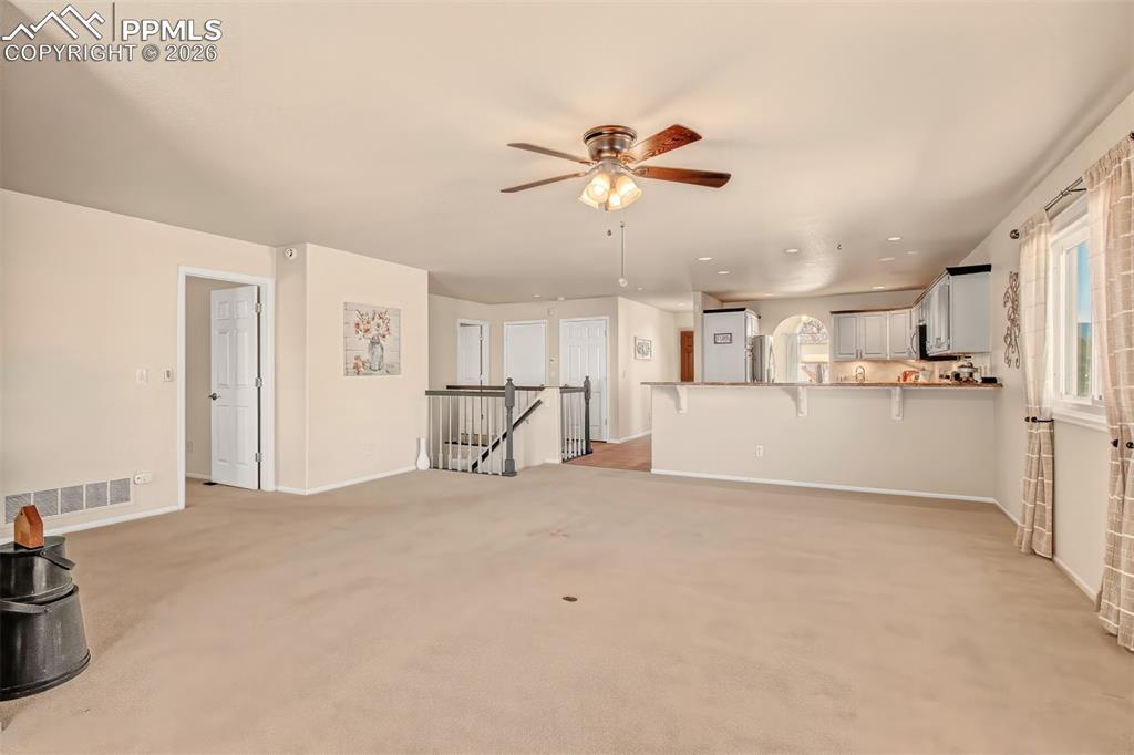 Living room adjacent to the kitchen, complete with extra bar seating. 