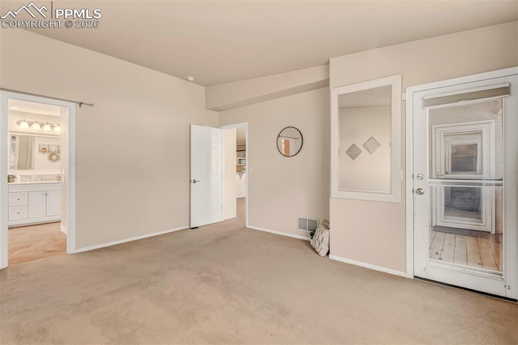 Master bedroom with direct access to the rear covered patio.