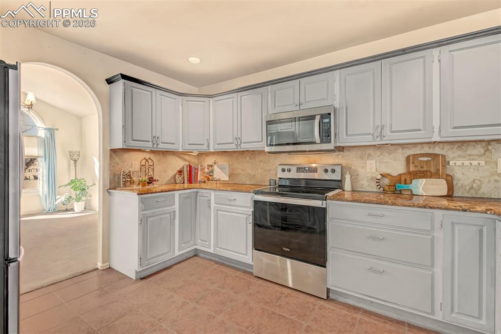 View of the kitchen leading into the formal dining room. 