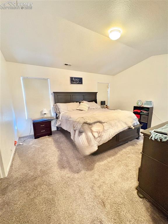 Bedroom featuring light carpet