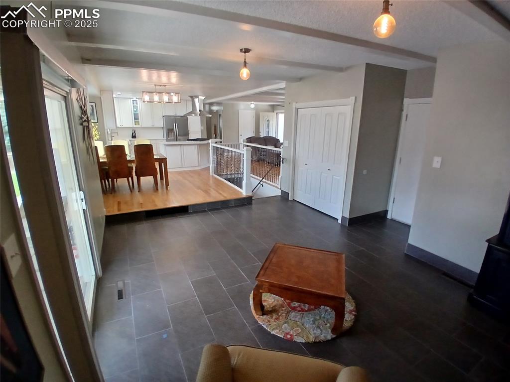 Main level family room featuring warm tile flooring
