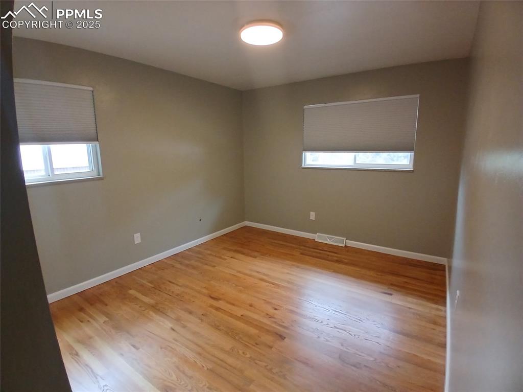 Spare room featuring hardwood / wood-style floors
