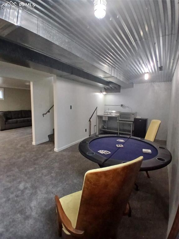 Wet Bar/Gane room with carpet.