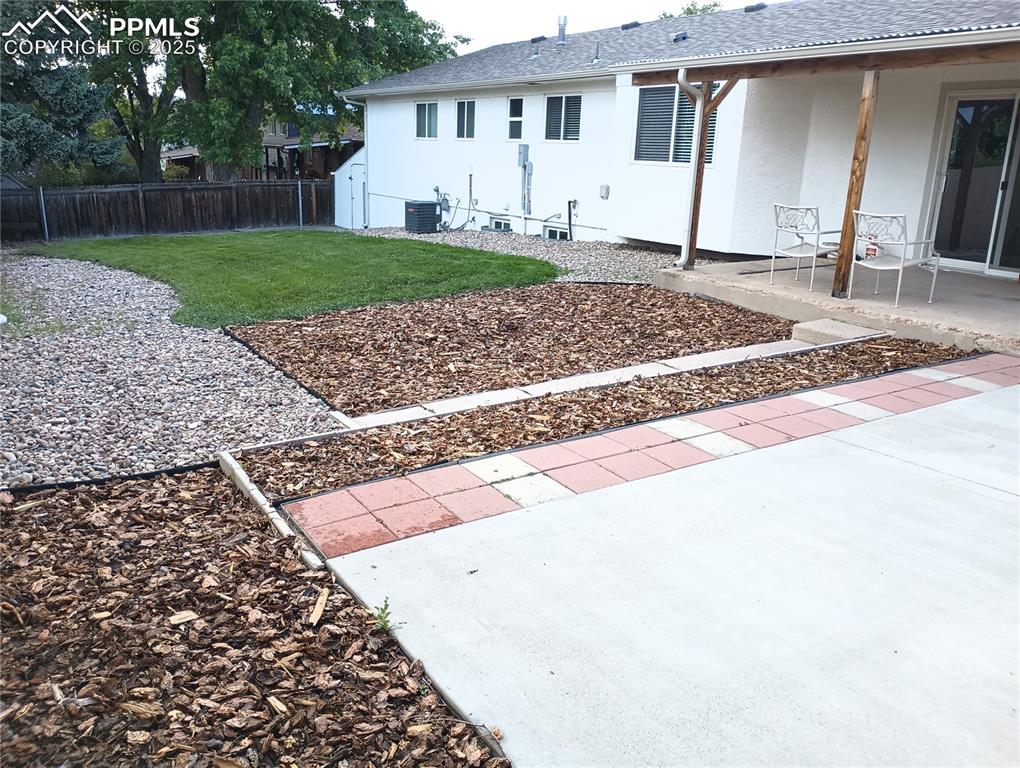 View of yard with a patio area and central AC unit