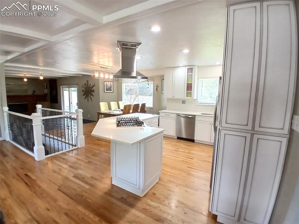 Kitchen featuring stainless steel island range hood with bluetooth speaker!!