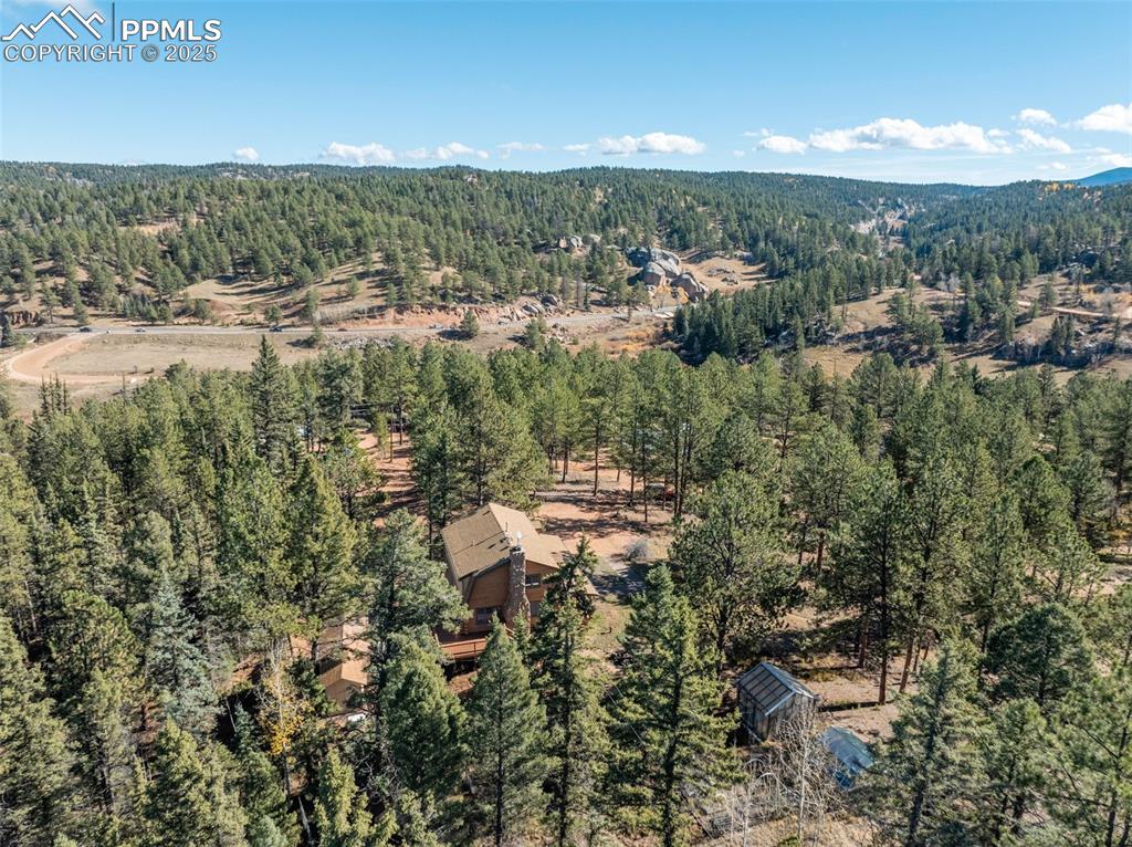 Aerial view of house and greenhouses