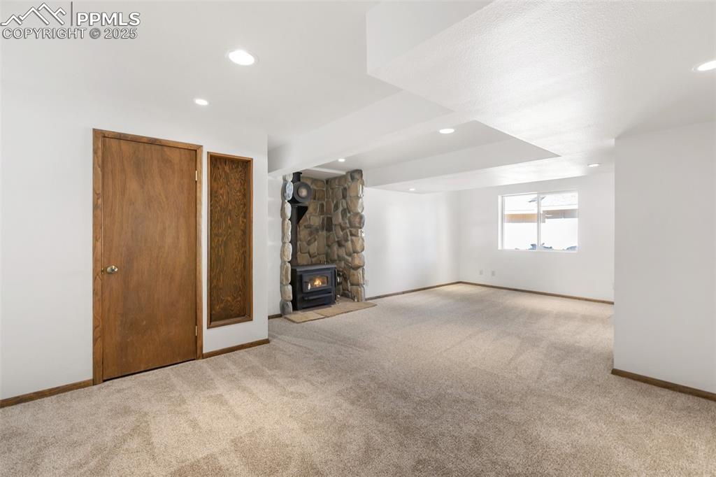 Lower level family room (walk-out) with wood burning stove, new carpet and paint.