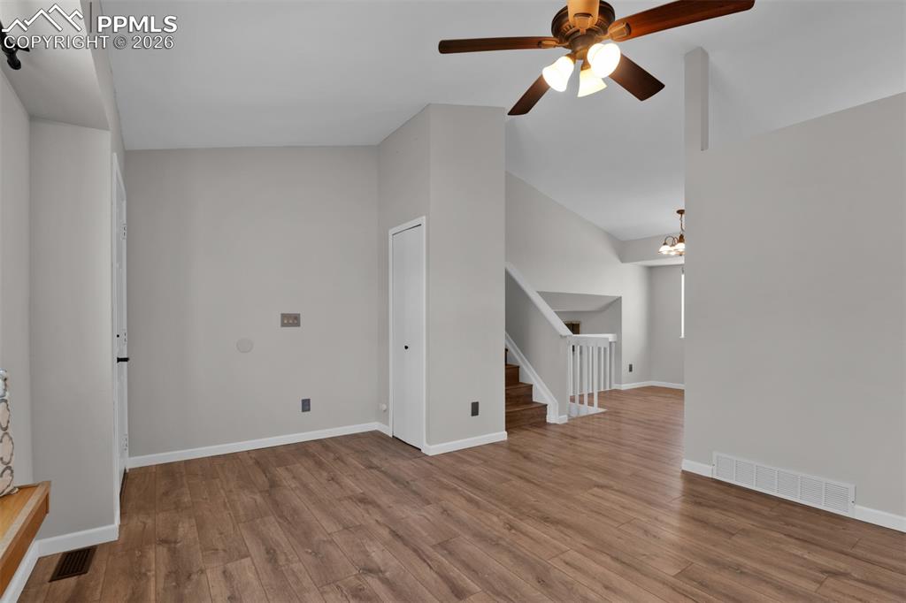 Opposite view of living room, entry and stairs. 