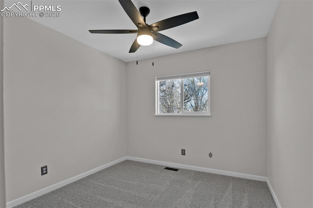 Secondary Bedroom #1 with new paint and new carpet.